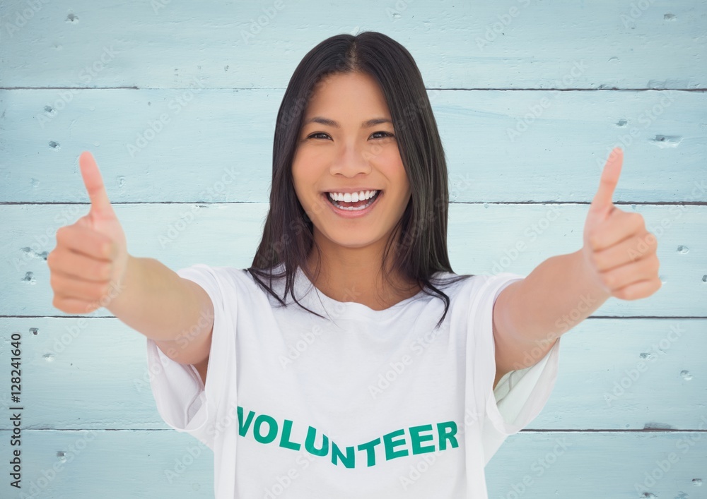 Smiling female volunteer showing thumbs up