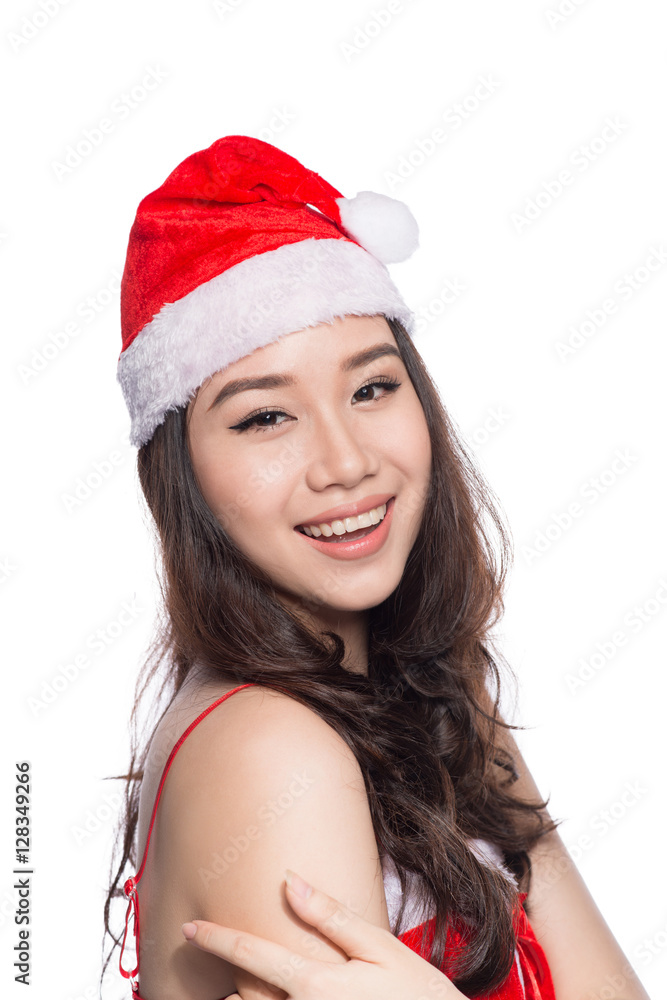 Christmas Woman. Beauty Asian Model Girl in Santa Hat isolated o