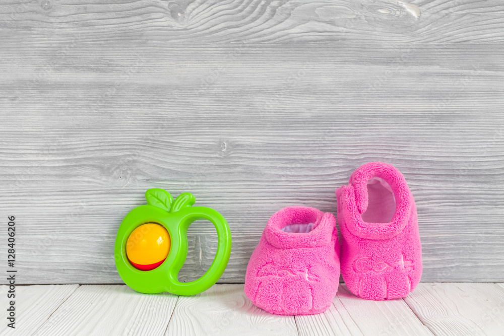 pink booties on wooden background