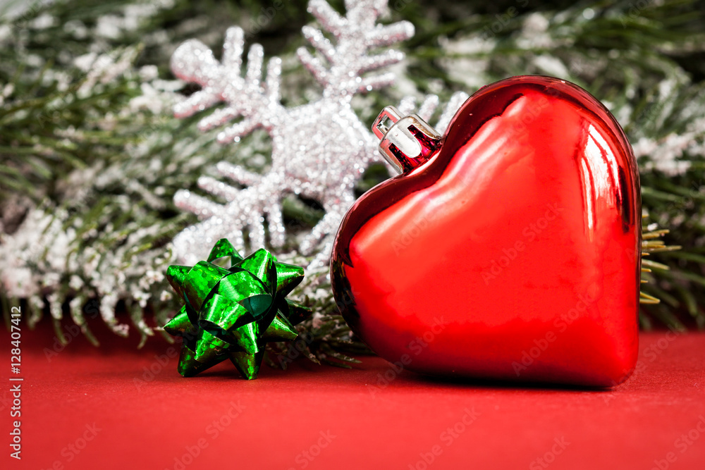 Christmas toys and spruce branches on red background top view