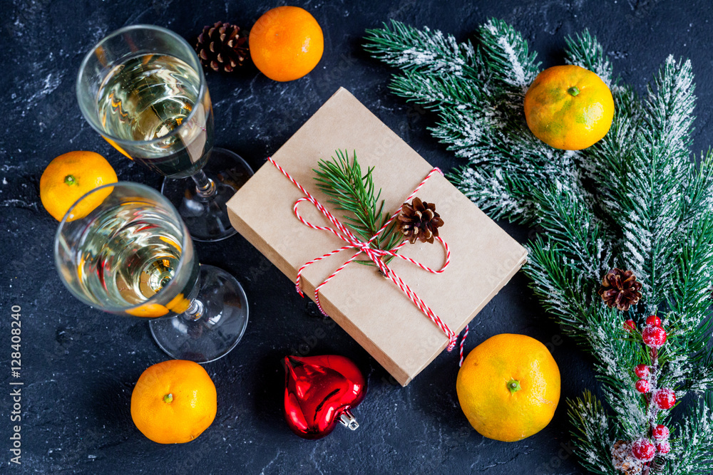 glasses and Christmas ornaments on dark background top view