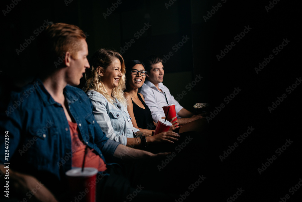 Young people watching movie in cinema.