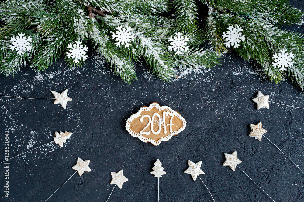 Christmas decorations, spruce branches on dark background top view