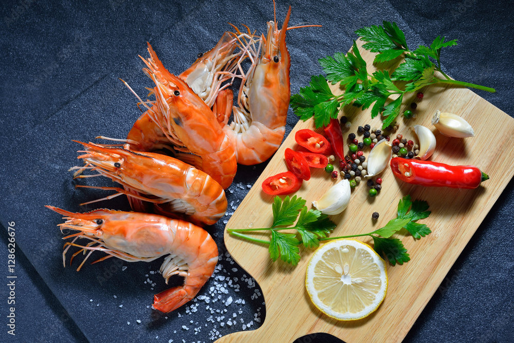 Cooked shrimps,prawns with seasonings on stone background