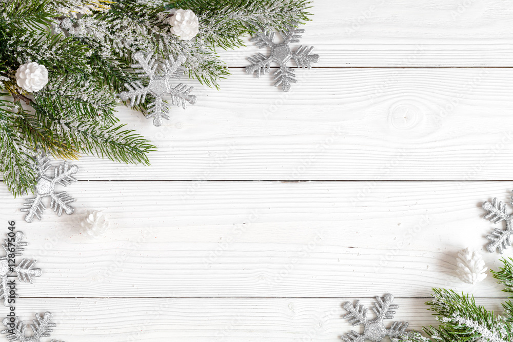 Christmas toys and spruce branches on wooden background top view