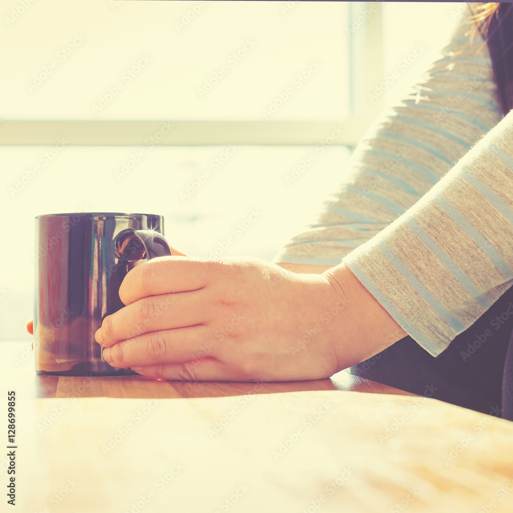 Young woman with cup of coffee