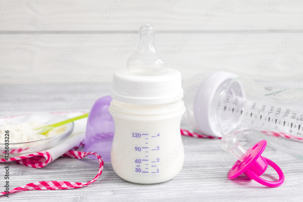 preparation of mixture baby feeding on wooden background