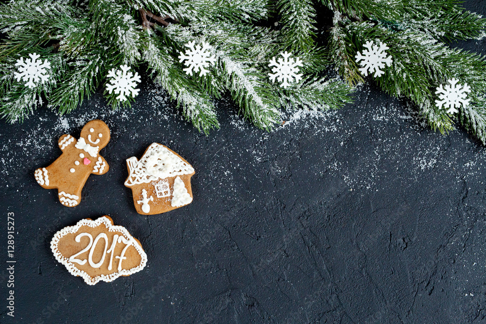 Christmas decorations, spruce branches on dark background top view