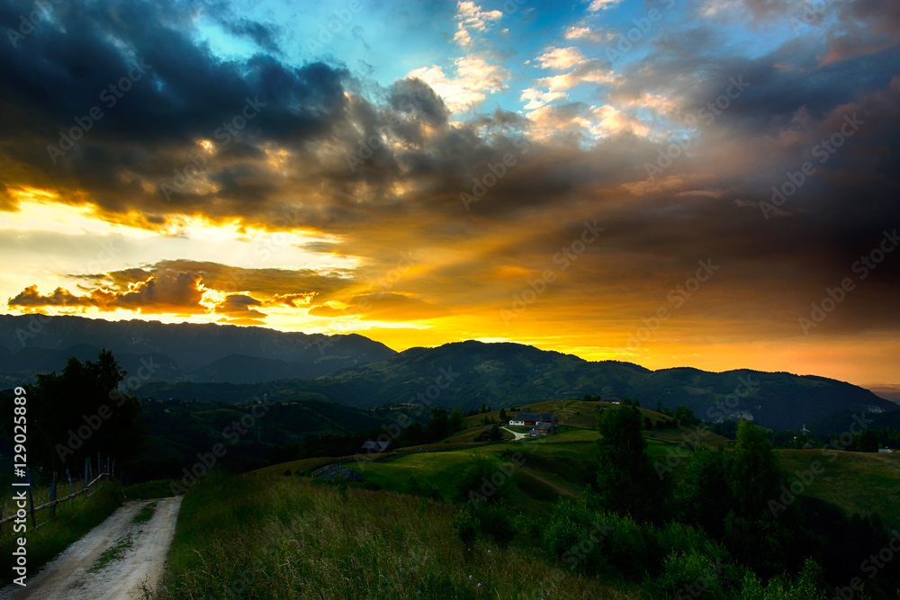 Evening, sunset on mountain hills of Simon village. Bran.