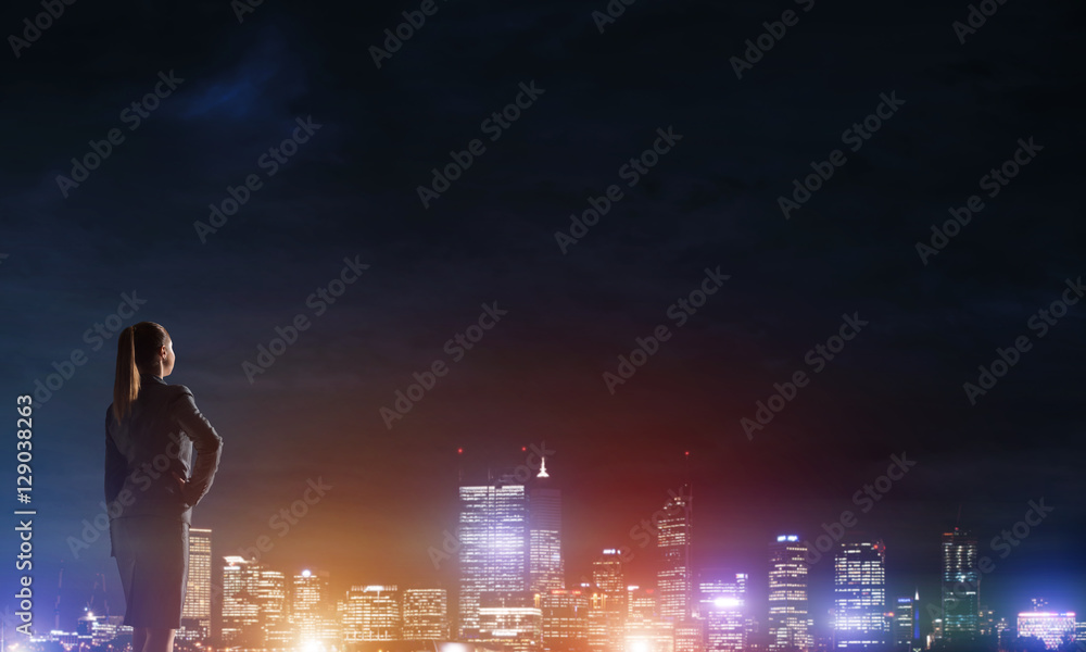 Woman looking at night city