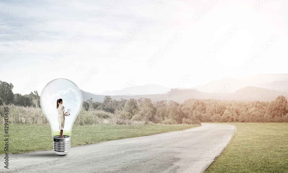 Businesswoman inside light bulb