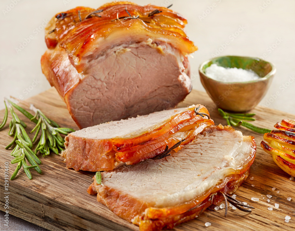 roasted pork on wooden cutting board