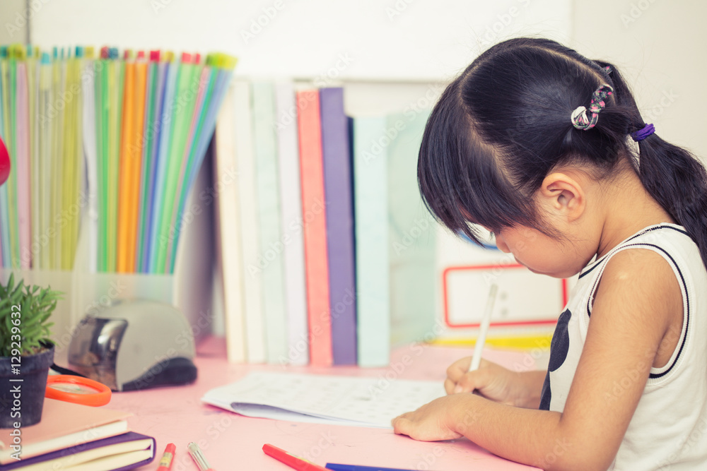 Cute little girl drawing picture using her imagination Vintage filter process style