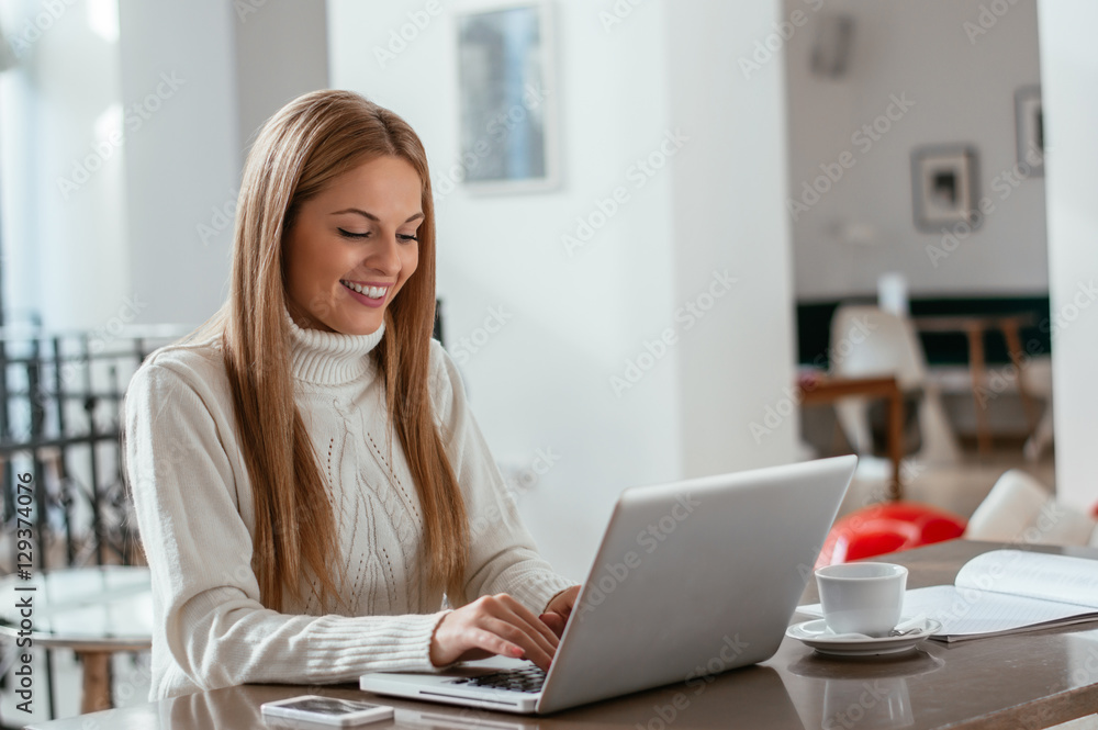 Business woman working on laptop computer at office