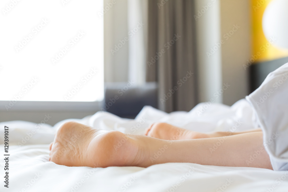 Womans feet sticking out from blanket