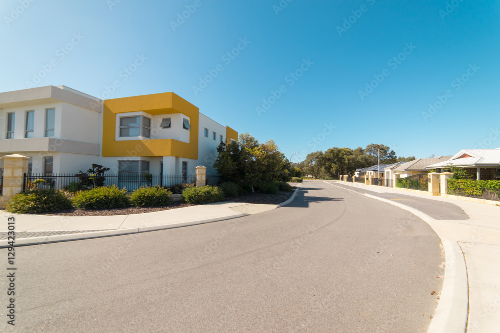 Asphalt road with modern terrace house in front on blue sky background. Yanchep Beach Town , Perth ,