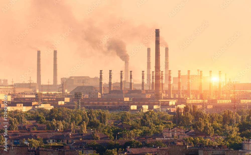 Metallurgy plant at sunset. Steel mill. Heavy industry factory. Steel factory with smog. Pipes with 