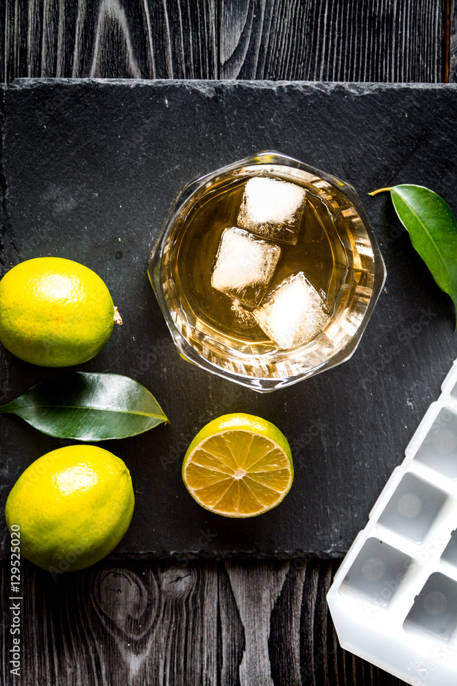 glass of scotch on dark wooden background top view