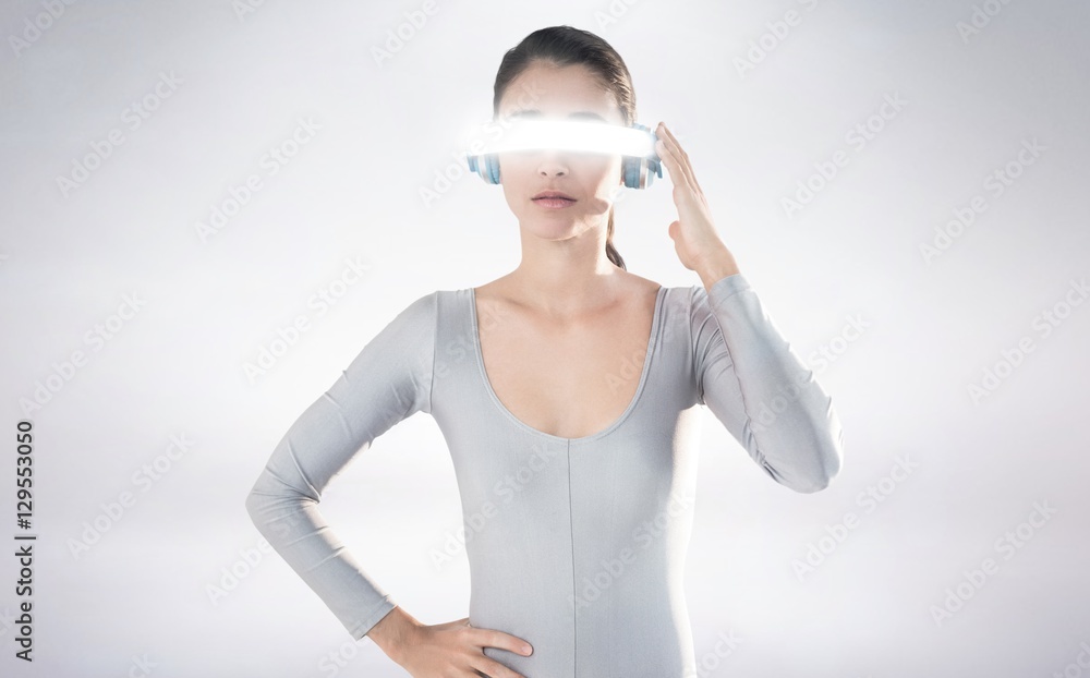 Composite image of beautiful woman using virtual video glasses