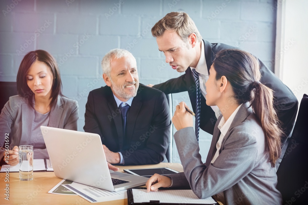 Businesspeople interacting in conference room