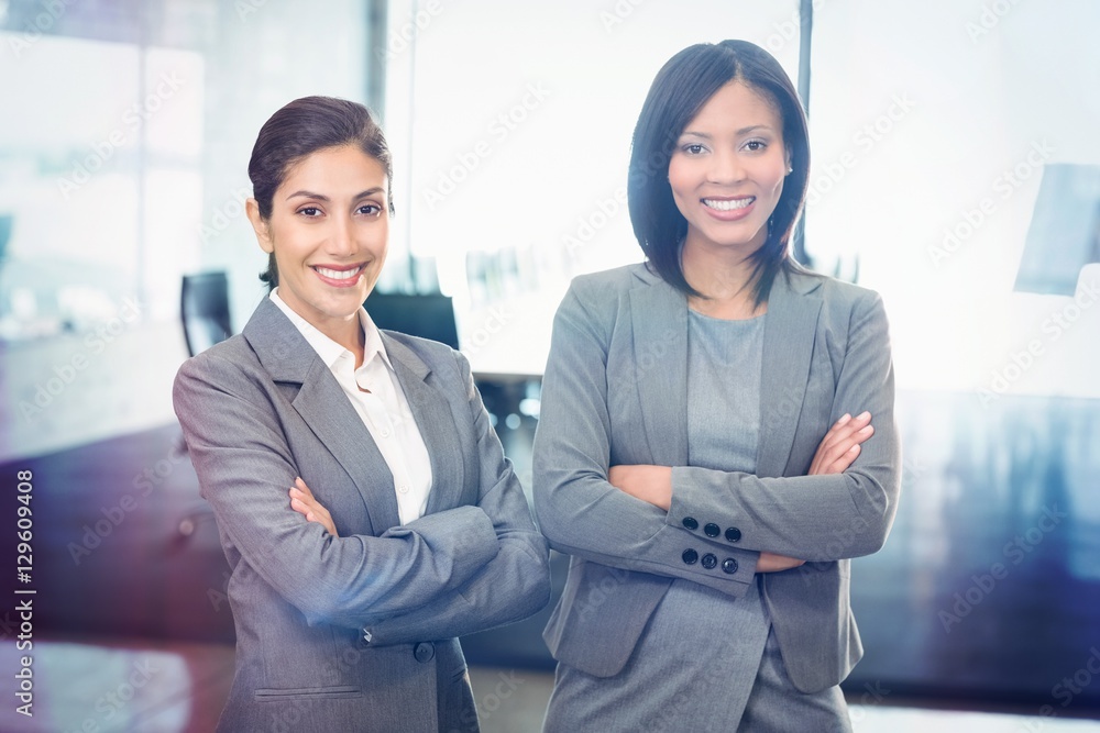 Portrait of businesswomen standing with arms crossed 