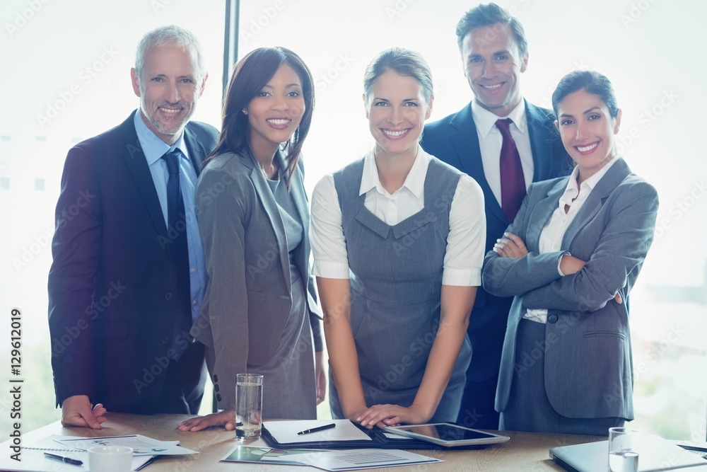 Portrait of business people standing together in conference room