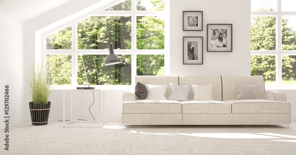 White room with sofa and green landscape in window. Scandinavian interior design