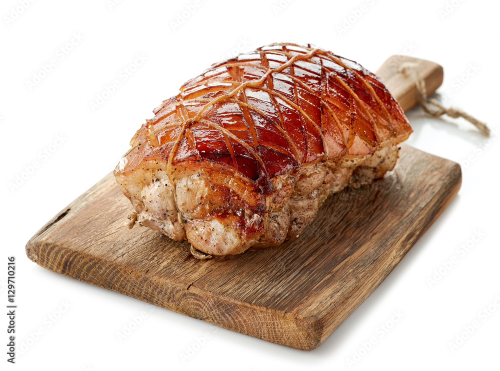 roasted pork on wooden cutting board