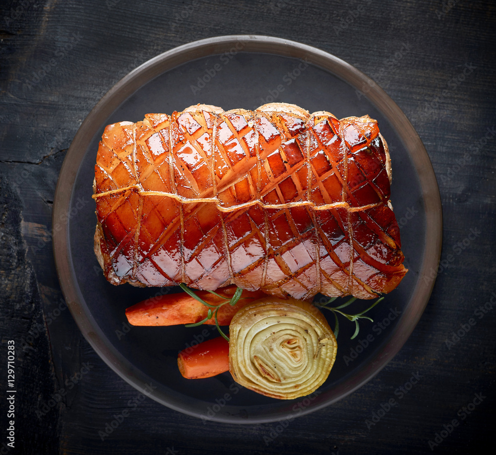 roasted pork on dark plate