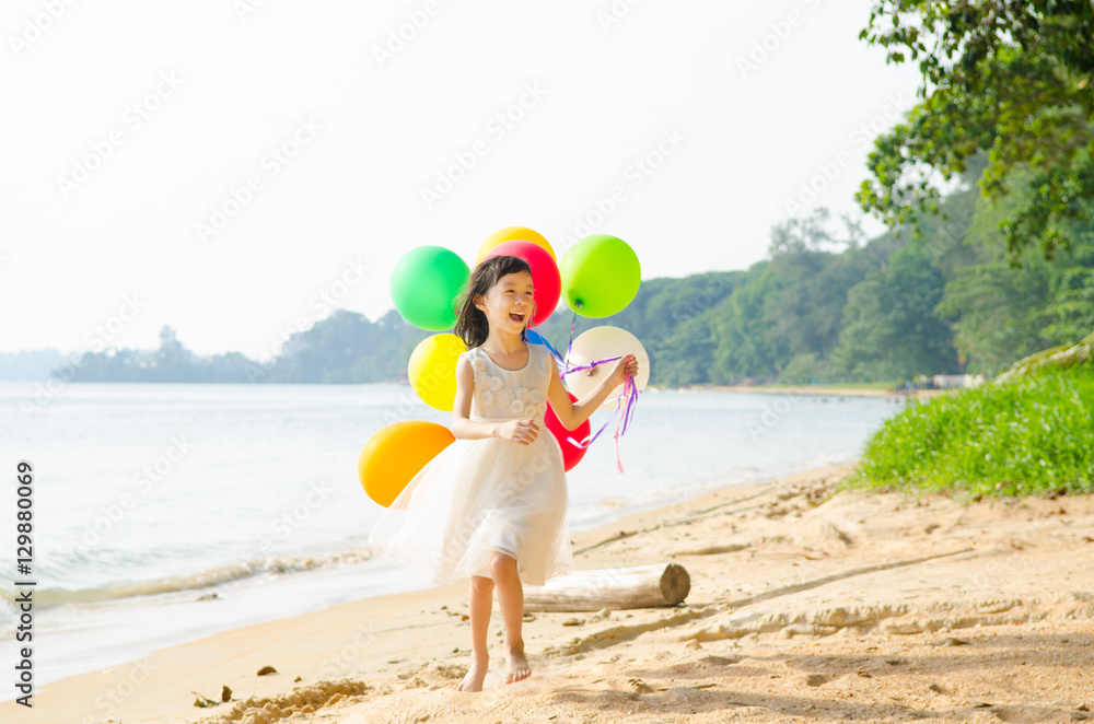 happy girl playing on the beach