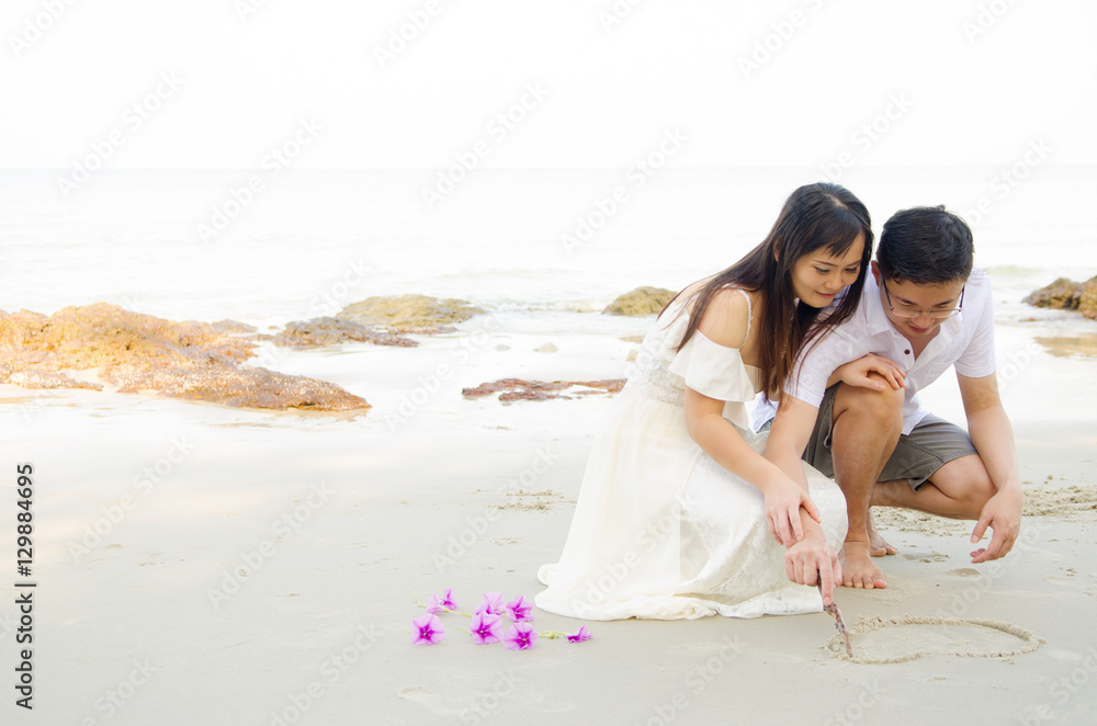 Outdoor Bride and groom on the beach  in the evening.