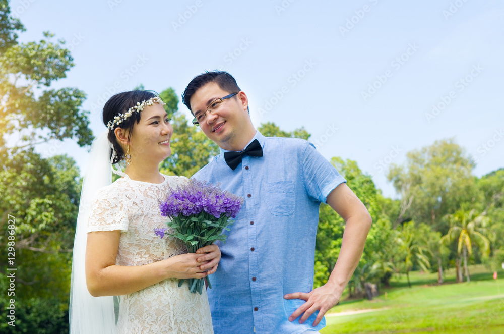 The asian couple embracing in the park