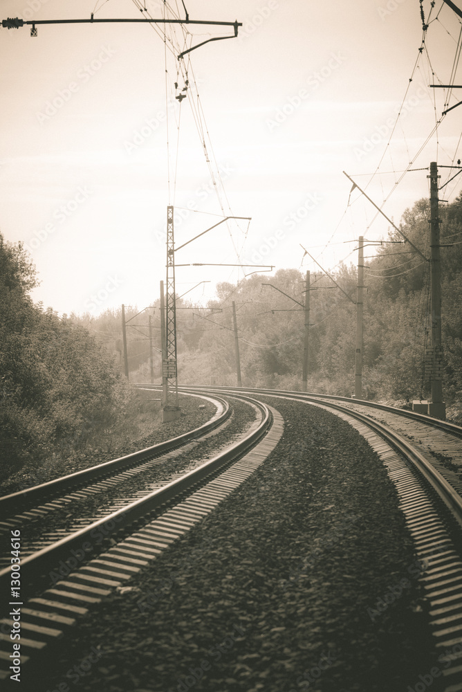 The train railway turns up left in summer landscape. Retro. Vintage.