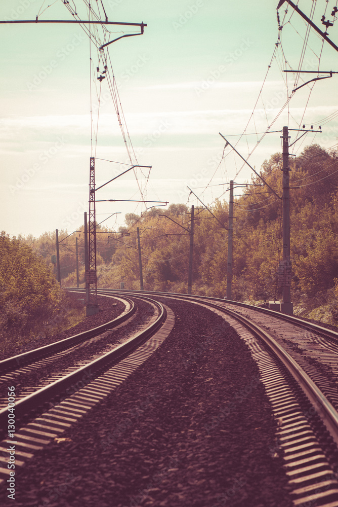 The train railway turns up left in summer landscape. Retro. Vintage.