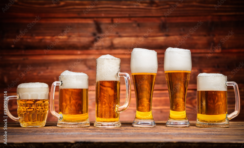 Glasses of lager served on old wooden planks