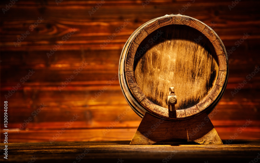 Wooden round barrel with old planks on background