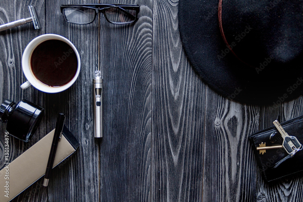 coffee, electronic cigarette, mens accessories dark wooden background top view