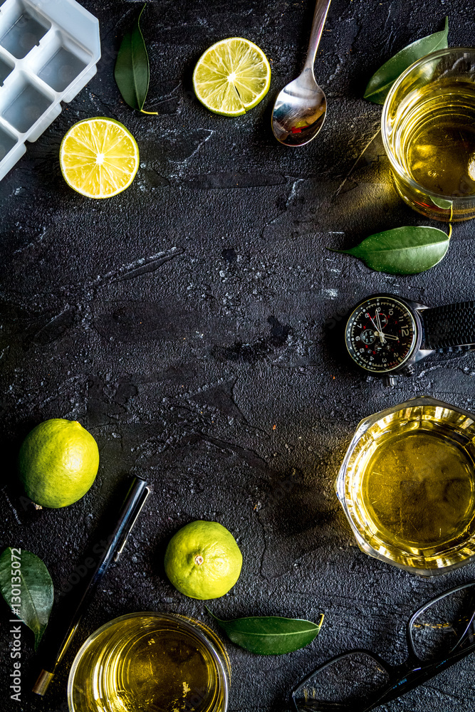 glass of scotch on dark background top view