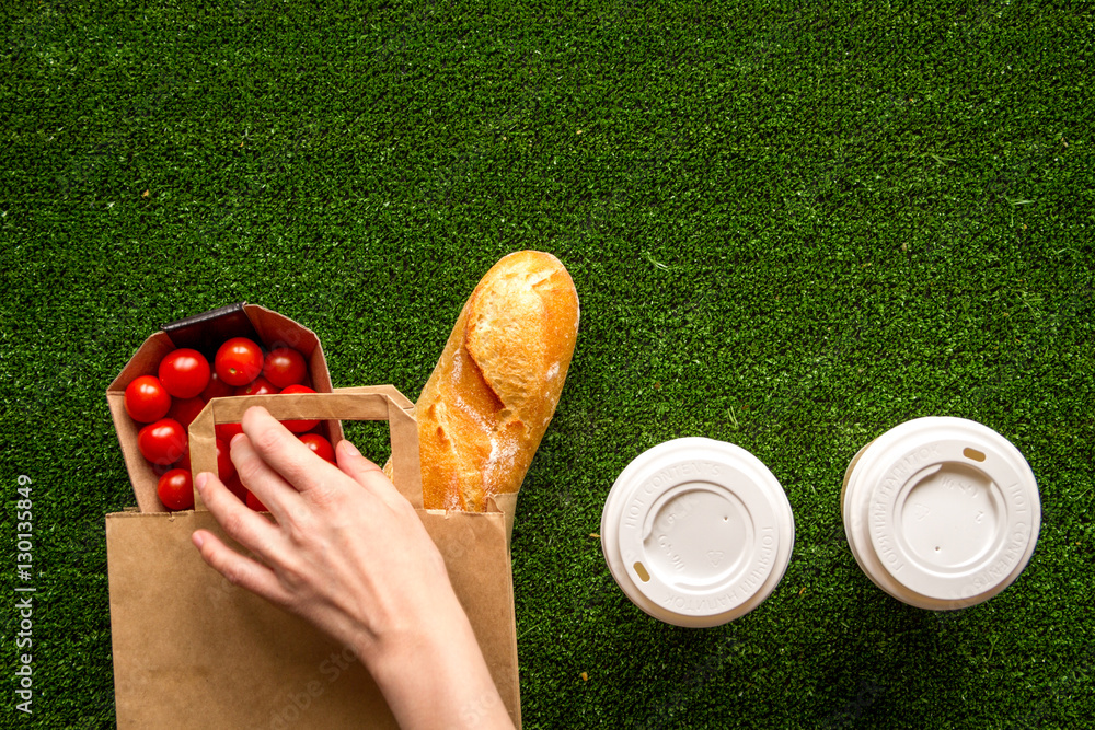 take out in paper bag on green background top view