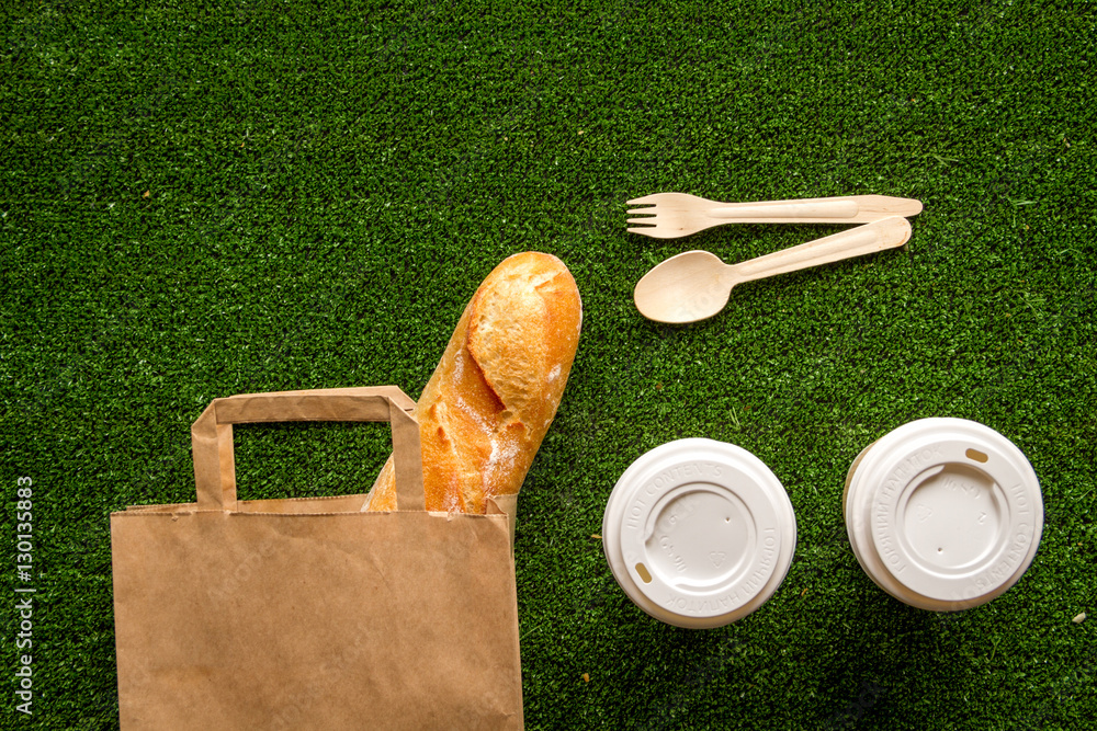 take out in paper bag on green background top view