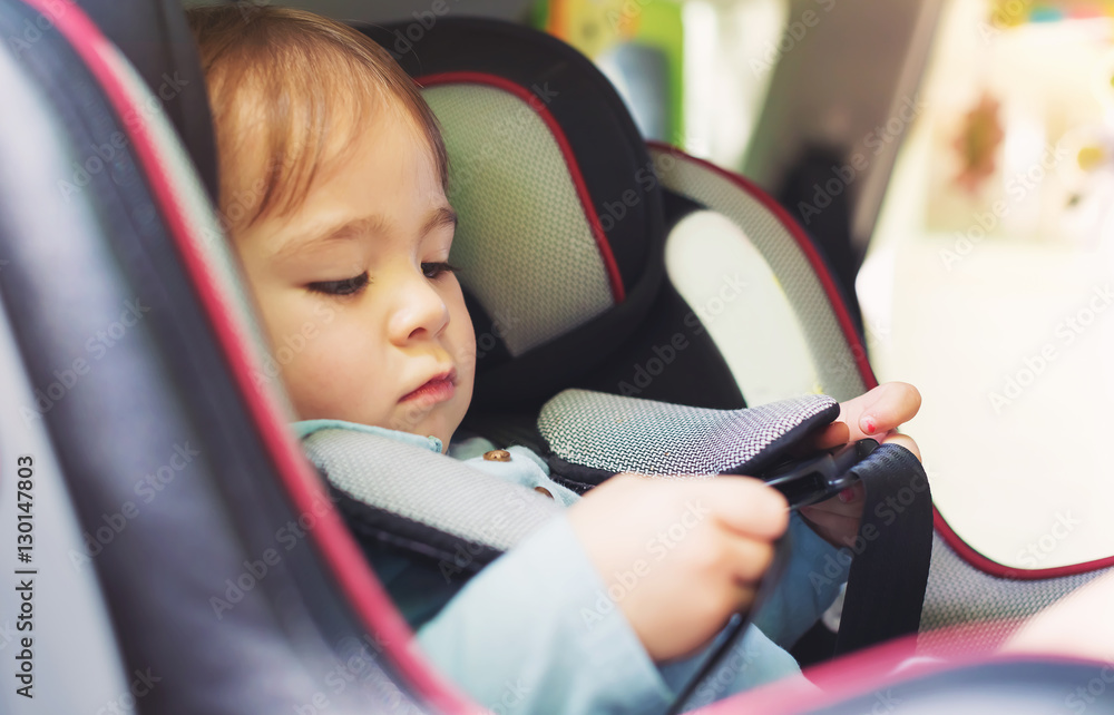 Toddler girl in her car seat