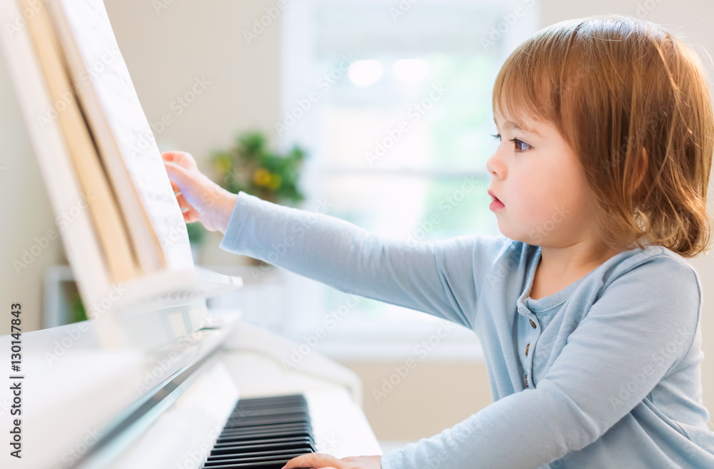 Toddler girl playing piano