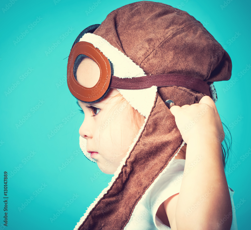 Toddler girl playing in pilot glasses