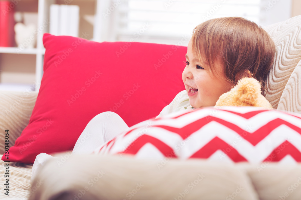 Toddler girl laughing in her living room