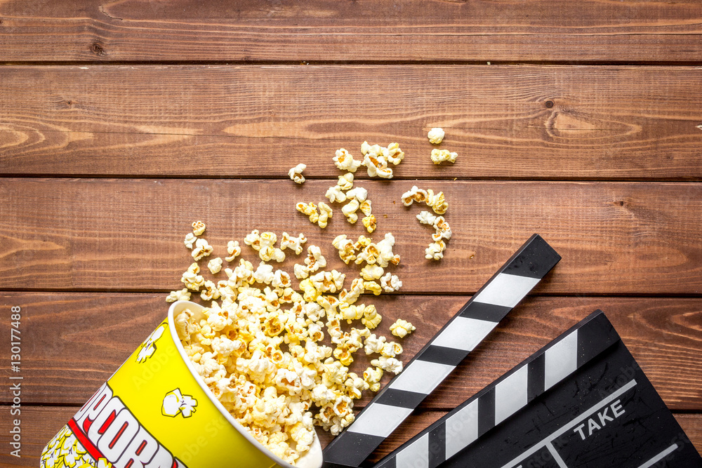 watching movie with popcorn on wooden background top view