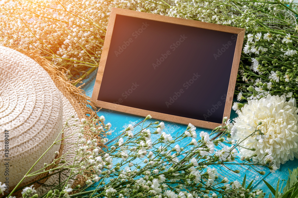 Beautiful blossom branch with framed blackboard over wooden back