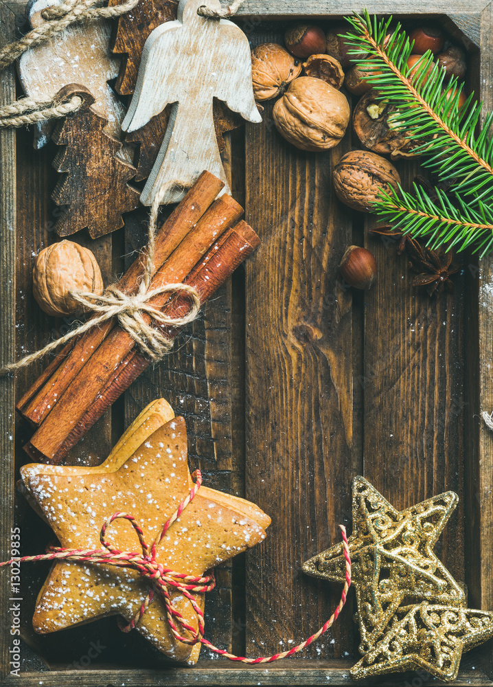 Sweet holiday gingerbread star shaped cookies, wooden angels, decorative golden stars, nuts, tied ci