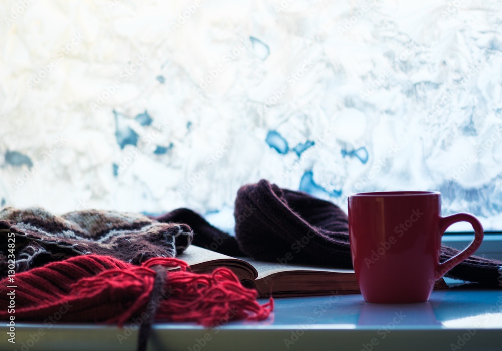 Mug of hot tea and warm woolen.