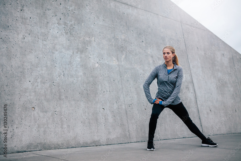 Young sports woman exercising outdoors