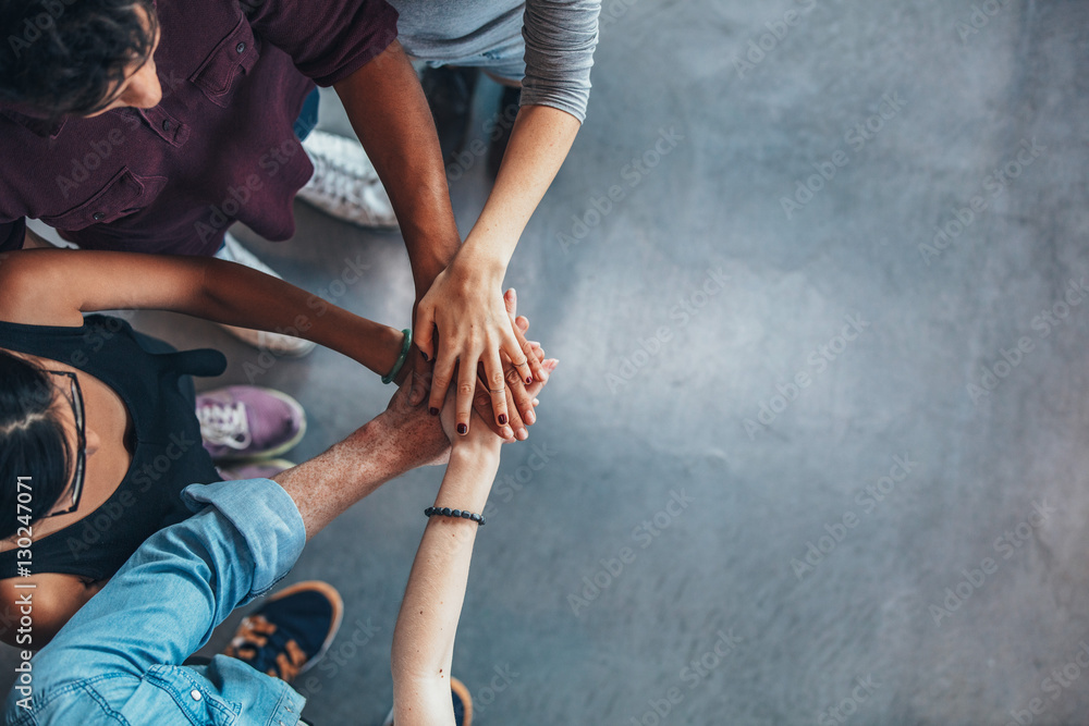 Group Of young people stacking their hands